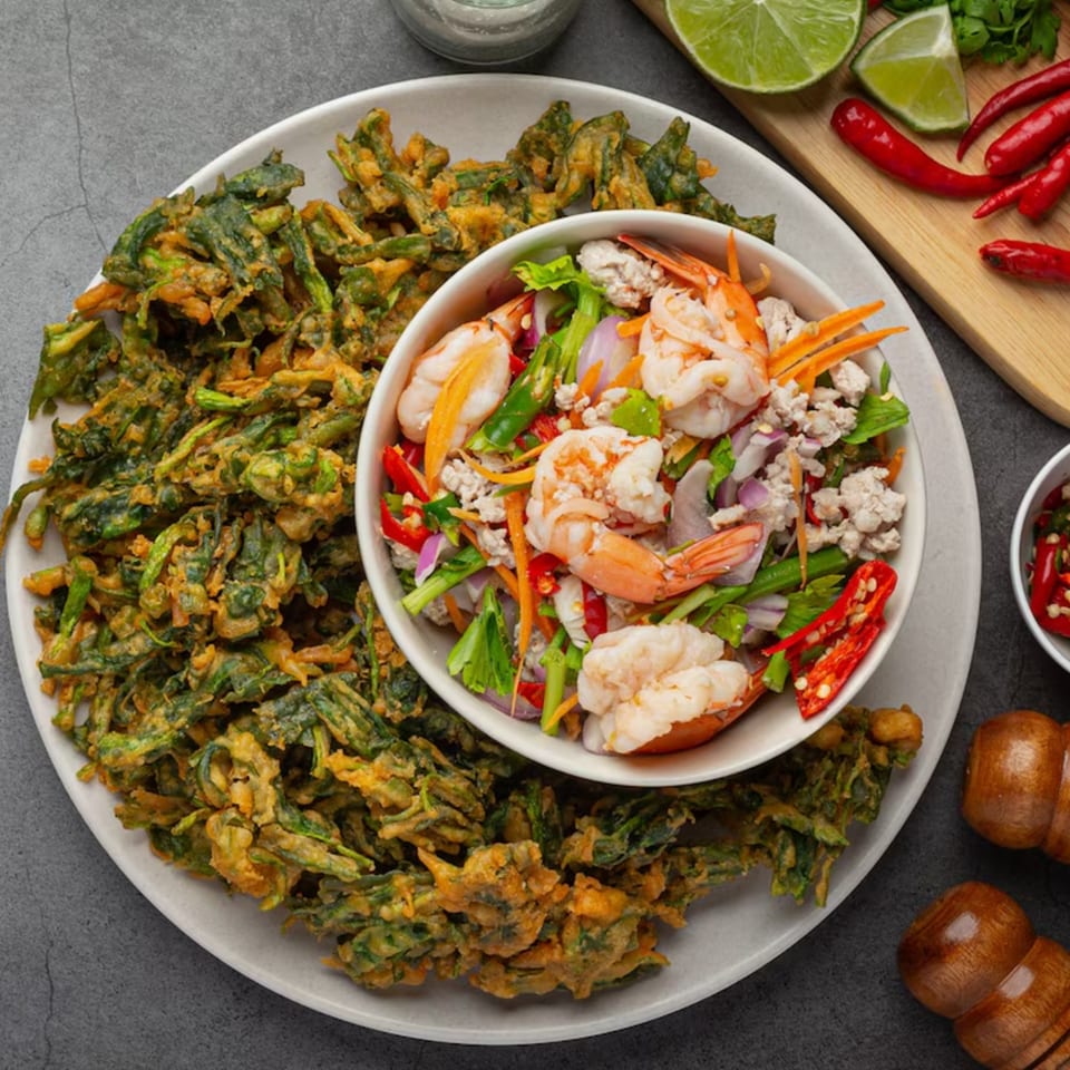 Crispy fried morning glory with a bowl of spicy shrimp and minced pork salad.